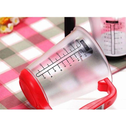 Digital Kitchen Scale With Measuring Cup, 1000g to 1g Precision clear measuring cup on scale with red handle showing g and ml markings