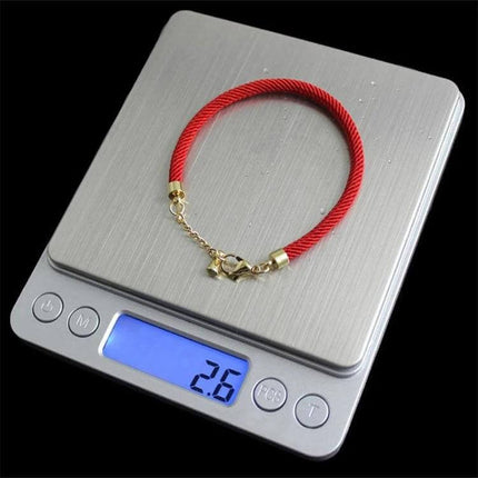 Digital Scale With Stainless Steel Platform For Jewelry And Coins showing a red bracelet on the 4x4 inch stainless steel 2kg capacity scale displaying 2.6g