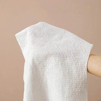 Disposable Compressed Towels 14 Pack For Travel And Daily Use - soft absorbent cotton travel towel in hand, ideal for cleansing and makeup removal