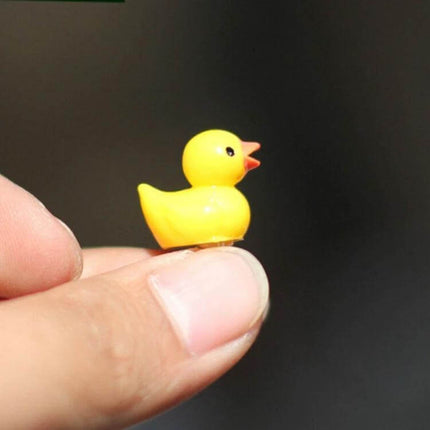 Dollhouse Yellow Duck Plant Decor Mini Five Pack For Dollhouses - close-up of single resin yellow duck held on fingertip for miniature plant scenes