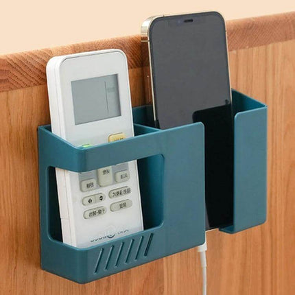 Double Grid Wall Mounted Storage Box For Remotes And Phone holding a remote and phone on wooden wall, with charging cable and strong tape mounting