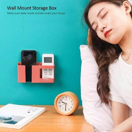 Double Grid Wall Mounted Storage Box For Remotes And Phone mounted on teal wall holding phone and remote next to bedside clock