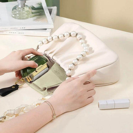 Double-Sided Clothing Lint Remover Roll for Clothes compact lint roller being used to clean a white purse and remove hair and dust