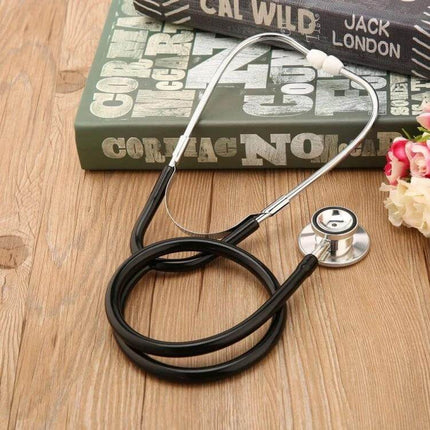 Double Sided Stethoscope With Aluminum Chestpiece Single Tube For Medical Exams on wooden table with books and flowers, 44mm aluminum chestpiece