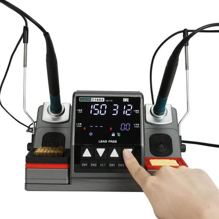 Dual Handles Soldering Station For Small-Joint Projects showing two handles, digital display and a hand adjusting controls for precision work