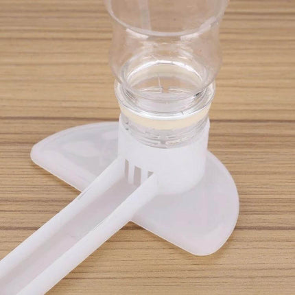 Duckbill Type Water Feeder For Beekeeping Outside The Hive white plastic duckbill water feeder placed outside hive on wooden surface