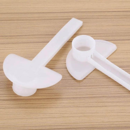 Duckbill Type Water Feeder For Beekeeping Outside The Hive plastic duckbill water feeder placed on wooden surface, long insertable end visible
