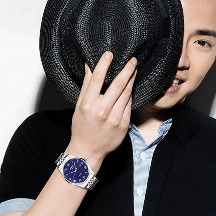SKMEI Waterproof Steel Quartz Wrist Watch for Everyday Outdoor Use on wrist of smiling man wearing hat, blue dial, stainless steel band