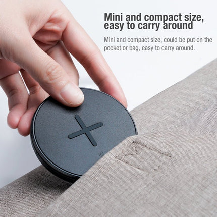 Nillkin MC026 Portable Wireless Charger 10W Fast Charge With Smart Chip compact anti-slip 10W wireless pad being placed into a bag pocket