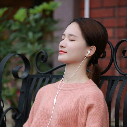 REMAX In Ear Sleep Earphones With Low Profile Comfort Fit woman relaxing on bench wearing low-profile white in-ear sleep earphones