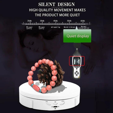 USB Electric Rotating Turntable for Photography Displays showing silent design with bracelet and pine cone on white rotating platform