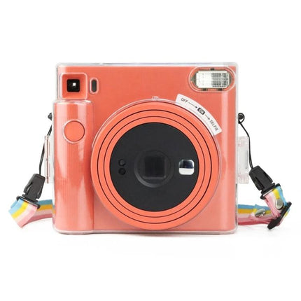 Clear Crystal Camera Bag for Fujifilm Instax Square SQ1 with Shoulder Strap showcasing a transparent protective cover on a coral Instax camera