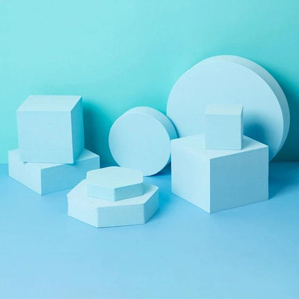 Solid Color Geometric Shapes Polymer Foam Props for Photography arranged in blue cubes, circles and hexagon platforms for product staging