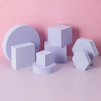 Solid Color Geometric Shapes Polymer Foam Props for Photography showing pastel purple cubes, hexagons, cylinders and round backdrop on pink background
