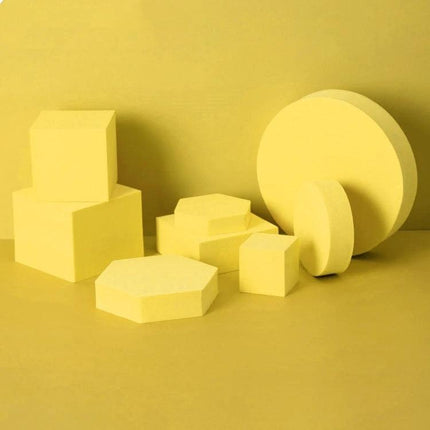 Solid Color Geometric Shapes Polymer Foam Props for Photography arranged yellow cubes, hexagon and discs for product staging and clean composition