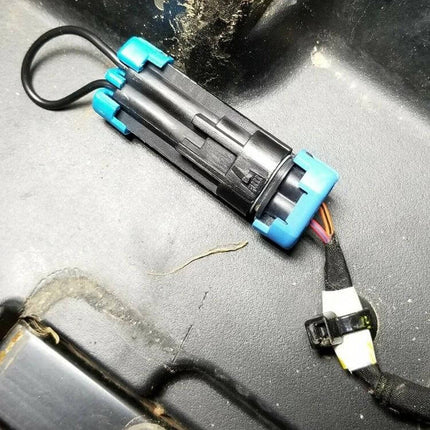 Polaris ATV Seat Belt Harness Bypass Plug with Cable Tie installed on seat wiring to bypass interlock and disable speed limiter