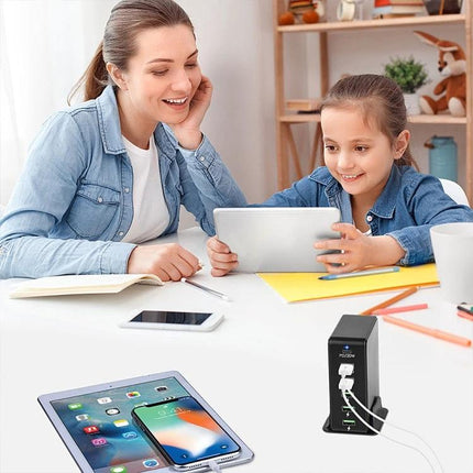 Versatile Multi-Port Charger for Travel Device Needs shown on desk charging multiple devices with mother and child using tablet