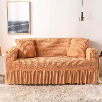 Stretch Sofa Cover With Skirt for Double M 145-185cm Sofas displayed in beige seersucker fabric with lotus-leaf skirt and straps on a modern sofa