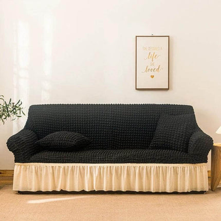 Stretch Sofa Cover With Skirt for Double M 145-185cm Sofas in black seersucker fabric with cream lotus-leaf skirt, elastic straps and protective fit