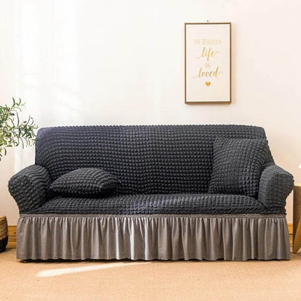 Stretch Sofa Cover With Skirt for Double M 145-185cm Sofas in dark gray seersucker fabric with lotus-leaf skirt, elastic straps and fitted protective cover