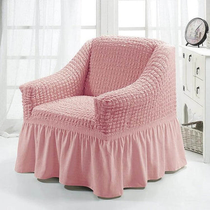 Four Seasons Universal Elastic Skirt Style Sofa Cover 90-140cm on pink armchair, polyester elastic full-coverage slipcover protecting sofa from pets and kids