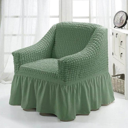 Four Seasons Universal Elastic Skirt Style Sofa Cover 90-140cm in sage green on armchair, fitted elastic skirt protects furniture from pets and kids
