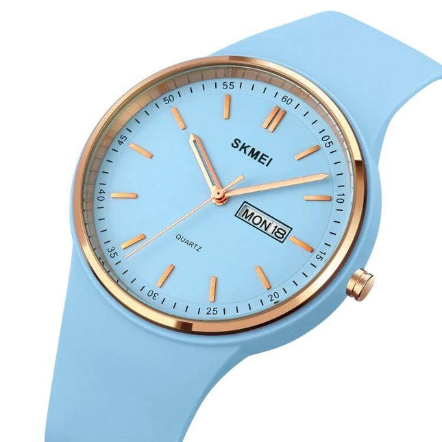 SKMEI Ladies Quartz Watch with Silicone Strap and Daily Functions slim light blue silicone strap watch with gold-tone bezel and day-date display
