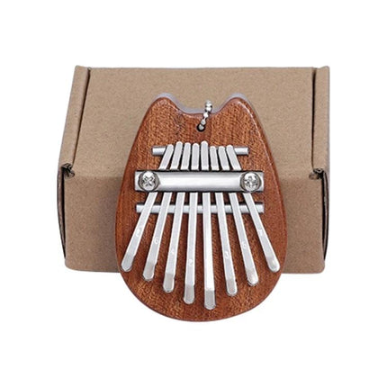Thumb Piano Kalimba for Relaxing Moments in Daily Life - compact wooden 8-note thumb piano on cardboard box for home relaxation