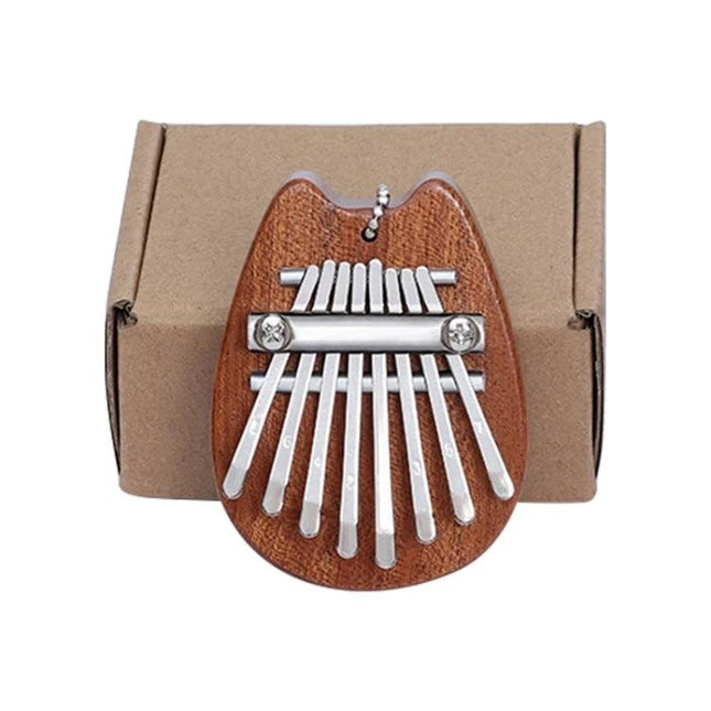 Thumb Piano Kalimba for Relaxing Moments in Daily Life - compact wooden 8-note thumb piano on cardboard box for home relaxation