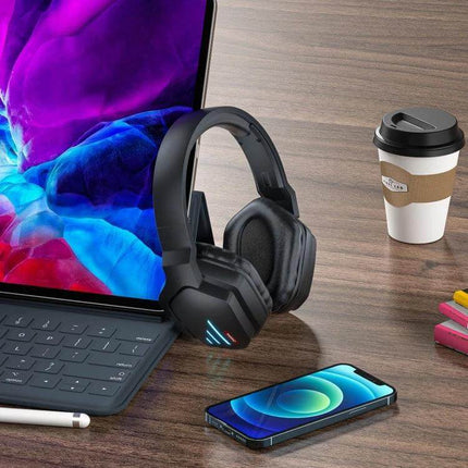 Onikuma Bluetooth Gaming Headset With Mic For PC And Console shown with laptop, phone, and coffee on desk