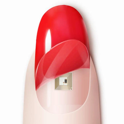 JAKCOM Nail Chip for Everyday Contactless Daily Use slim NFC device on a red manicured nail showing the chip under a clear nail sticker