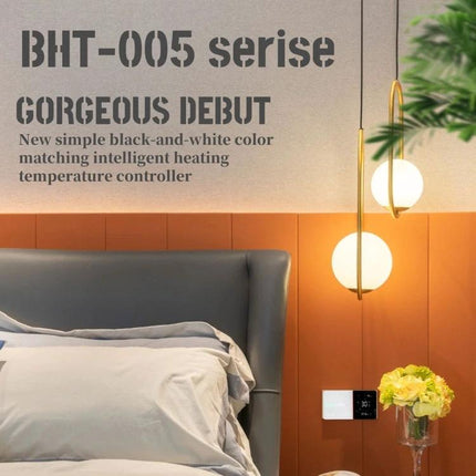 Smart Home Heating Thermostat with Internal Sensor Control mounted on bedroom wall near bed and modern pendant lights