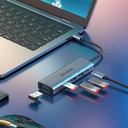 Amalink USB-C Hub for Expanding Laptop Ports and Charging connected to laptop with multiple USB drives and charging cable