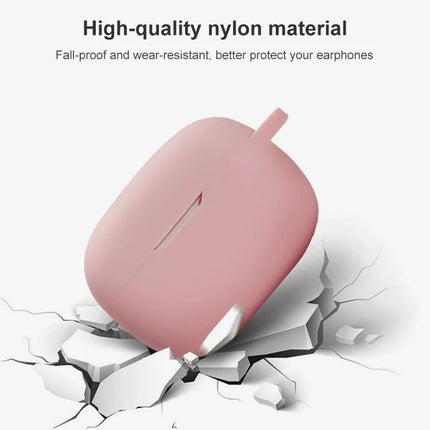 Protect Your JBL Earphones During Daily Commutes With This Silicone Case pink silicone nylon protective earphone case shown on cracked surface