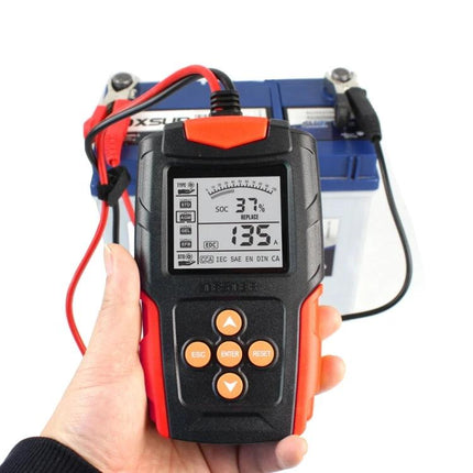 Foxsur Car Battery Tester for Everyday Vehicle Maintenance handheld device showing battery readings connected to a car battery