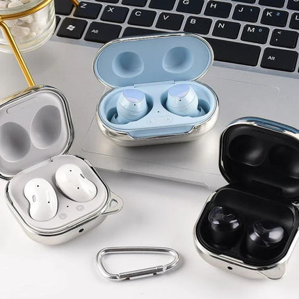 Sleek Protective Case for Samsung Galaxy Buds in Daily Use - three metallic cases protecting earbuds on a laptop, commuter-ready durable fit
