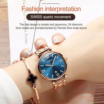 JIN SHI DUN Elegant Waterproof Women's Quartz Watch rose gold tungsten steel strap blue dial with Roman numerals on wrist