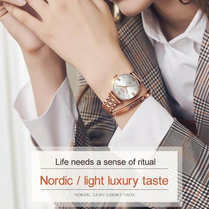 JIN SHI DUN Elegant Waterproof Women's Quartz Watch shown on a woman's wrist with tungsten steel strap and Roman numerals, 30m water resistance