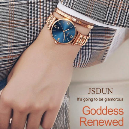 JIN SHI DUN Elegant Waterproof Women's Quartz Watch on wrist with tungsten steel rose gold strap and blue dial, Roman numerals, 30m water resistant