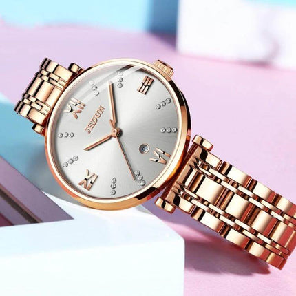 JIN SHI DUN Elegant Waterproof Women's Quartz Watch rose gold tungsten steel strap with Roman numerals and crystal markers, 30m water resistant