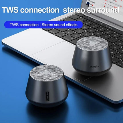 Lenovo Portable Bluetooth Speaker For Home And Outdoor Use shown as two compact metallic speakers next to a laptop