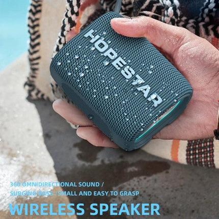 HOPESTAR Portable Bluetooth Speaker For Home And Outdoor shown water-resistant in hand at picnic, compact and travel-ready