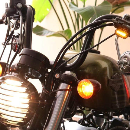 Rearview Mirror With LED Turn Signals For Harley Sportster Black installed on black Harley Sportster showing illuminated amber LED turn signal and black housing