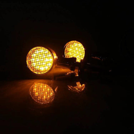 Universal Motorcycle LED Turn Signal Dual Color Yellow and Red – lit yellow LED signals with aluminum alloy housing reflected on surface, 12V universal fit