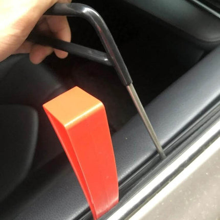 Paintless Dent Repair Kit for Car Hail Damage with 18 Tools - user inserting metal tool and red lever to push out car door dent (DIY)