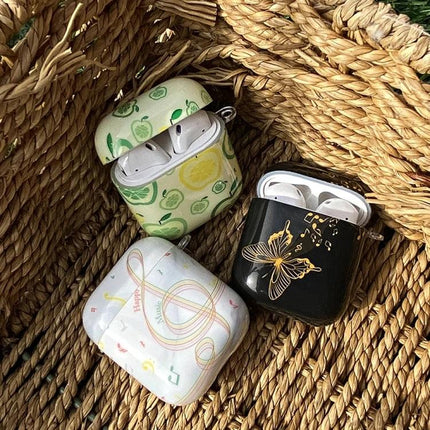 Protect Your AirPods During Daily Commutes with IMD Original Case - three decorative IMD cases (fruit, butterfly, music) in woven basket, AirPods inside