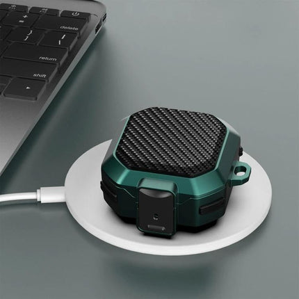 Protective Case for Samsung Earbuds During Daily Activities shown in green carbon-fiber design on wireless charger near laptop