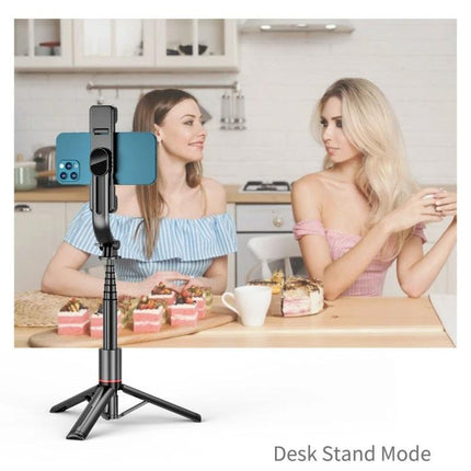 Extendable selfie stick for daily photos and videos on trips or at home — desk-stand mode with built-in lights capturing two women at a kitchen table