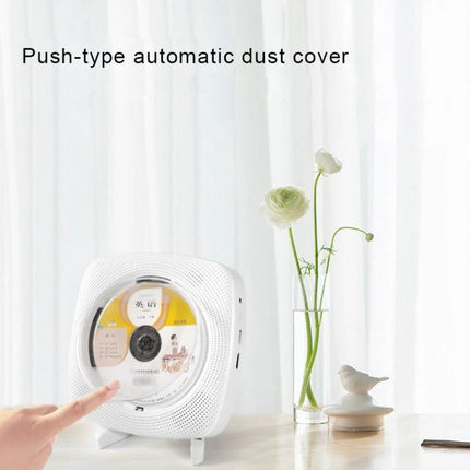 Kecag Wall Mounted DVD and CD Player with Bluetooth Connectivity push-type dust cover on white table, finger pressing disc tray