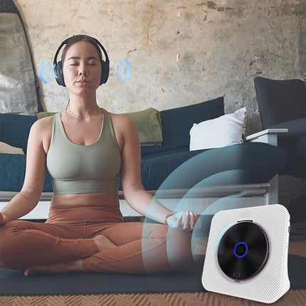 Kecag Retro Bluetooth CD Player with Rechargeable Battery on floor near woman meditating with headphones